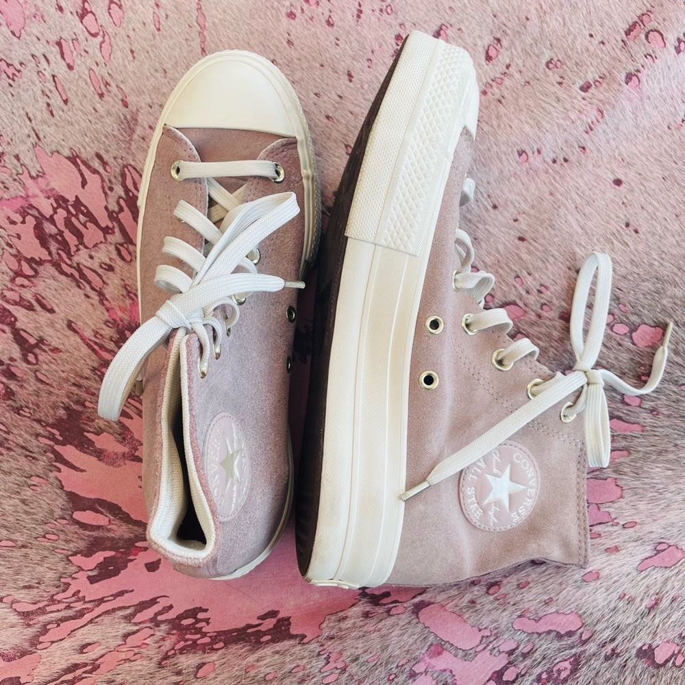 Lavender high top converse.